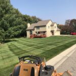 completed lawn care job and Scag Mower